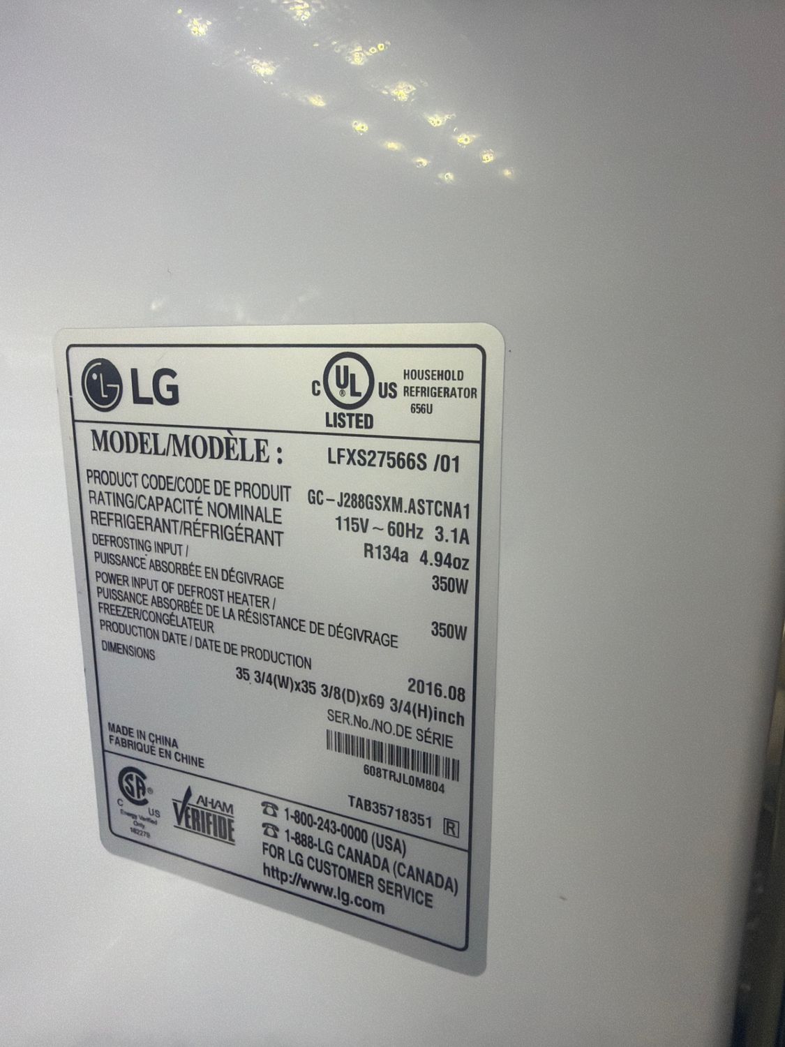 Model plate of the LG LFXS27566S refrigerator confirming the unit details during diagnosis in Calgary