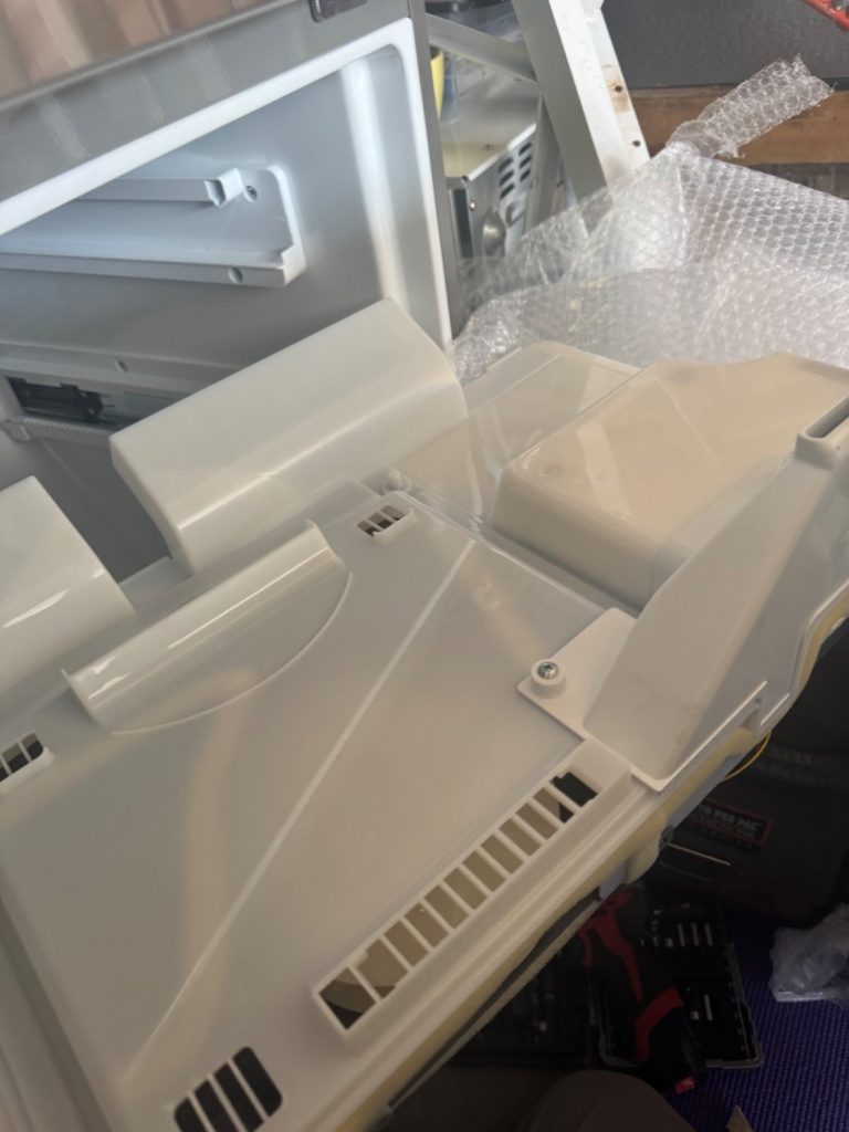 New LG evaporator cover assembly prepared for installation during a TechVill fridge repair in Savanna, Calgary