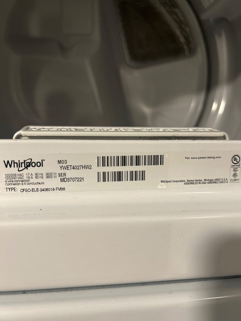 Whirlpool YWET4027HW laundry centre model plate above the dryer drum, photographed during TechVill diagnosis in Mahogany, Calgary