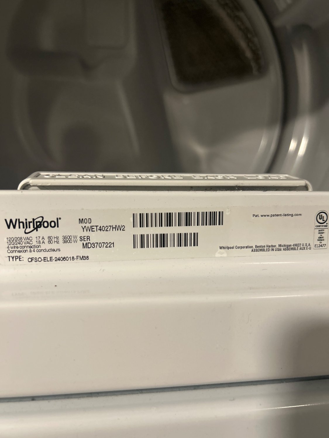 Whirlpool YWET4027HW laundry centre model plate above the dryer drum, photographed during TechVill diagnosis in Mahogany, Calgary