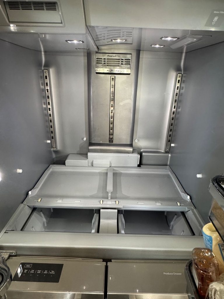 Fresh food compartment of a KitchenAid French door refrigerator in Evergreen, Calgary, with shelving removed during diagnosis