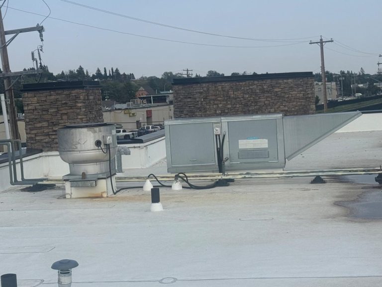 Rooftop commercial hood exhaust fan and rooftop ventilation unit at a business in Okotoks, Alberta
