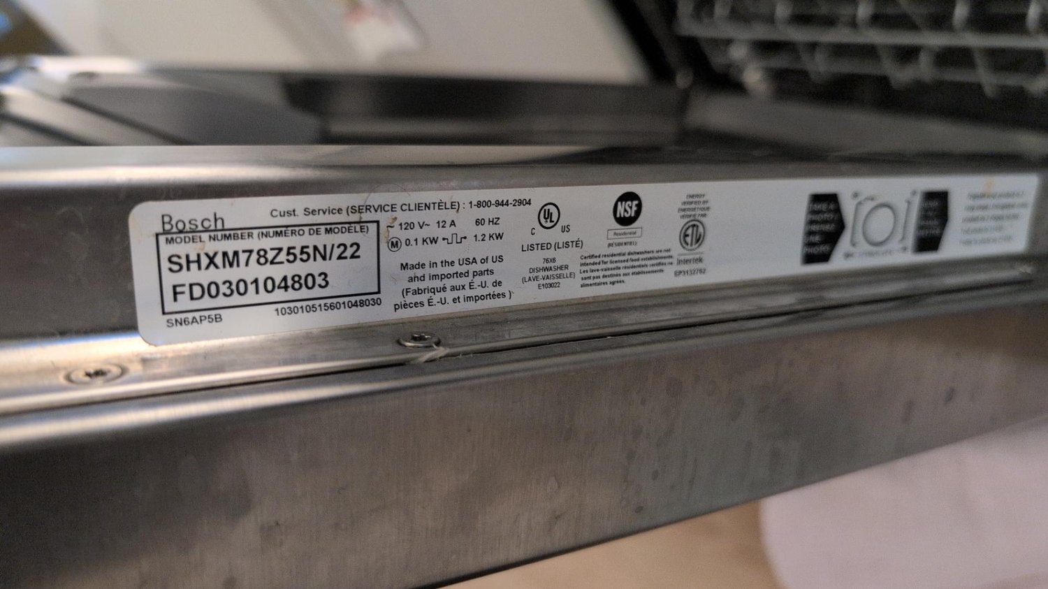 Rating plate on the door edge of a Bosch SHXM78Z55N/22 dishwasher showing model and serial number