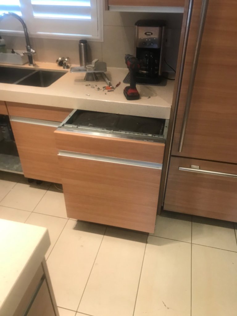Panel-ready Miele dishwasher pulled out of its cabinet with the filter assembly and spray arm removed for cleaning in Rockcliffe Park, Ottawa