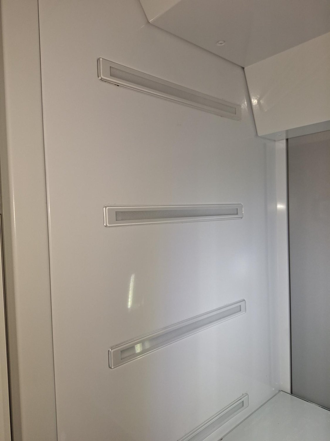 Recessed LED light strips and their covers inside the cabinet wall of a Miele built-in refrigerator
